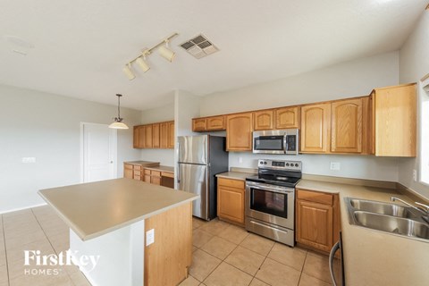a kitchen with stainless steel appliances and wooden cabinets