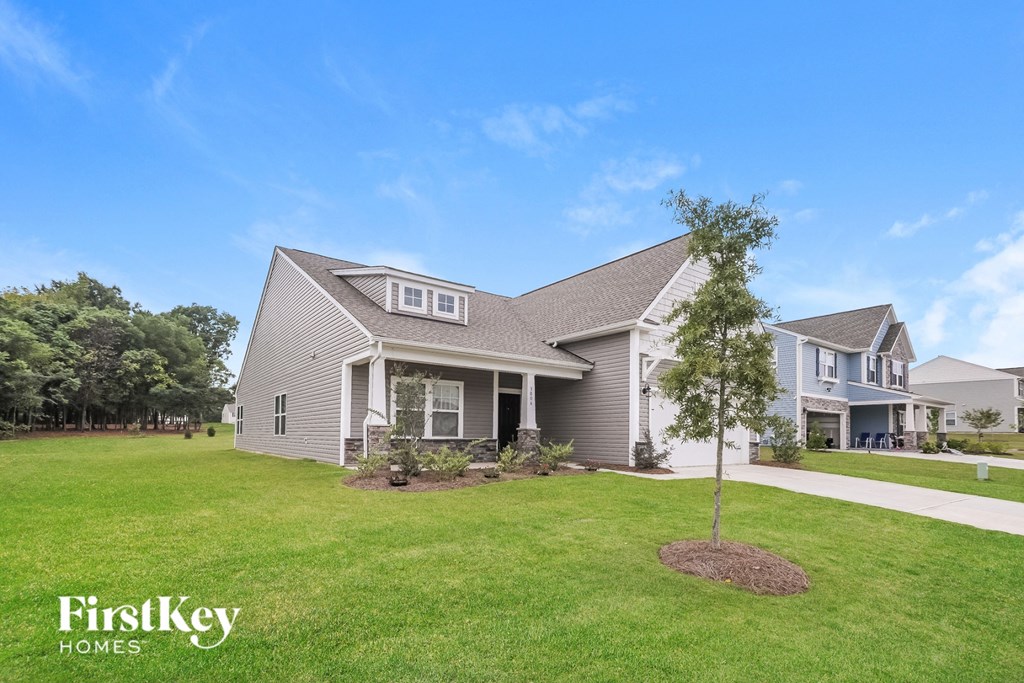 A house with a tree in front of it.