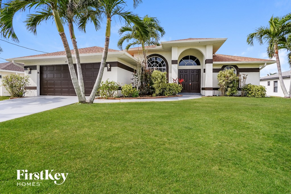 A house with a palm tree in front of it.