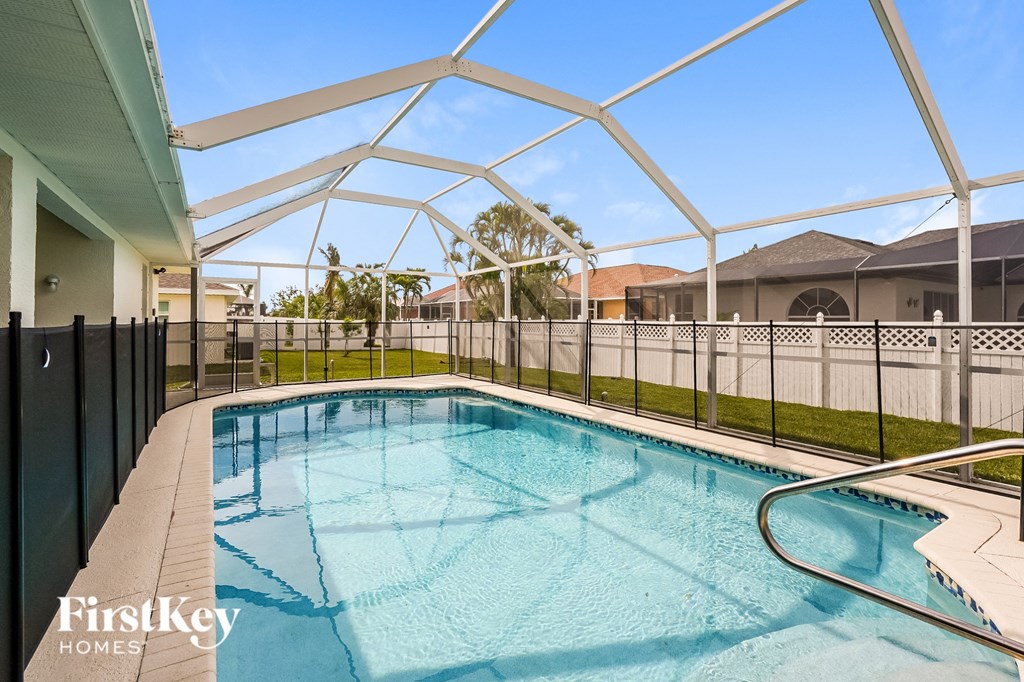 A swimming pool under a white roof with a FirstKey Homes logo.