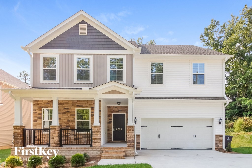 a white house with a front porch and a white garage door