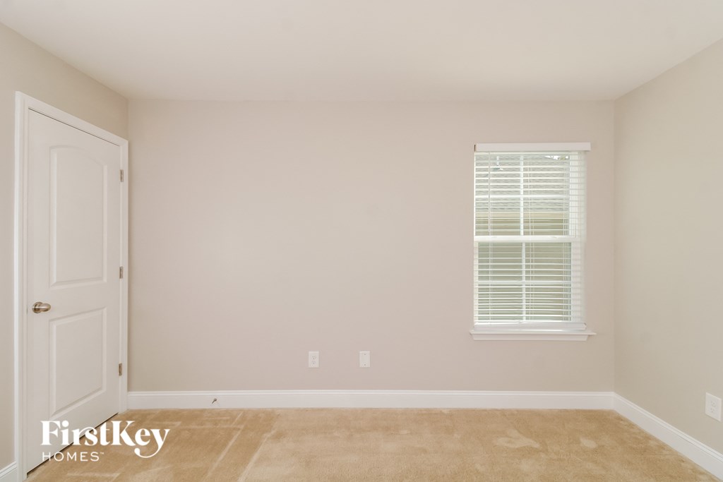a empty room with a door and a window