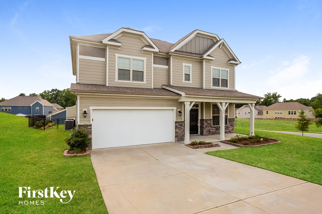 a beige house with a white garage door