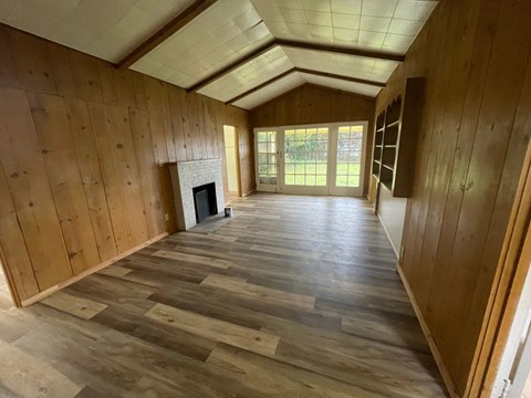 a living room with wood floors and a fireplace