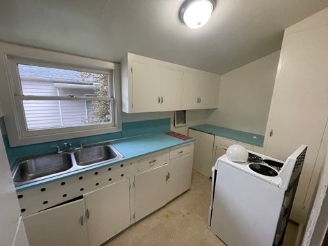 a kitchen with white appliances and blue counter tops