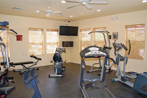 Exercise machines in fitness center-Matthew Henson IV Apartments, Phoenix, AZ