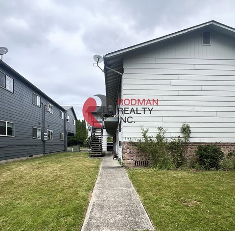 A building with the words "Prodman Realty Inc." painted on it.