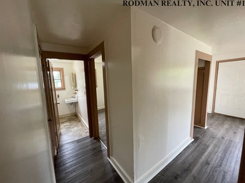 a view of the living room from the hallway into the bedroom and the bathroom