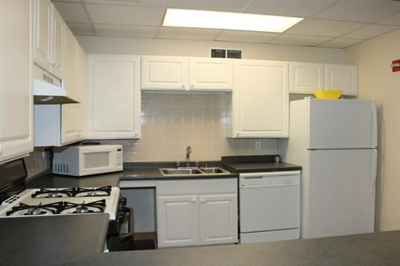 a white kitchen with white appliances and white cabinets