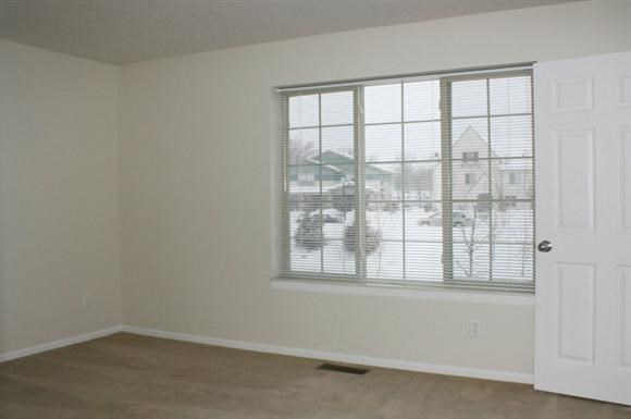 an empty room with a window and a door