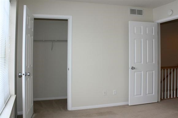 an empty room with a closet and a door