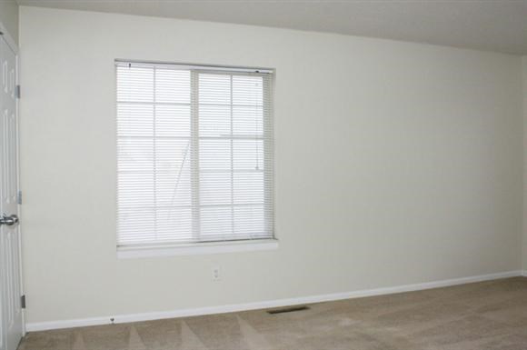 an empty room with a window and a door