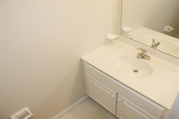 a white bathroom with a sink and a mirror