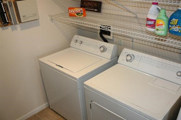 a white washer and dryer in a closet