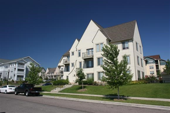 a truck parked in front of an apartment building