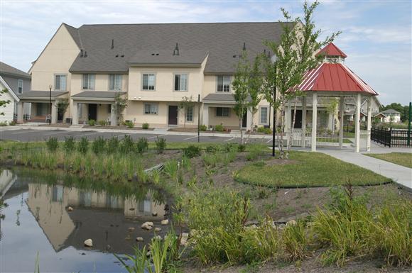 a building with a gazebo and a pond