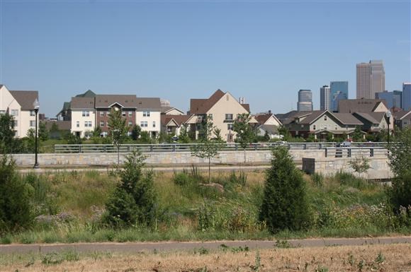 a group of houses in front of a field