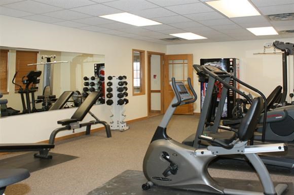 a gym with a lot of exercise equipment in it