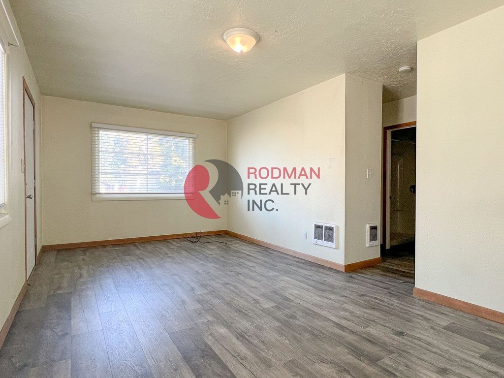 A room with Rodman Realty Inc. written on the wall.