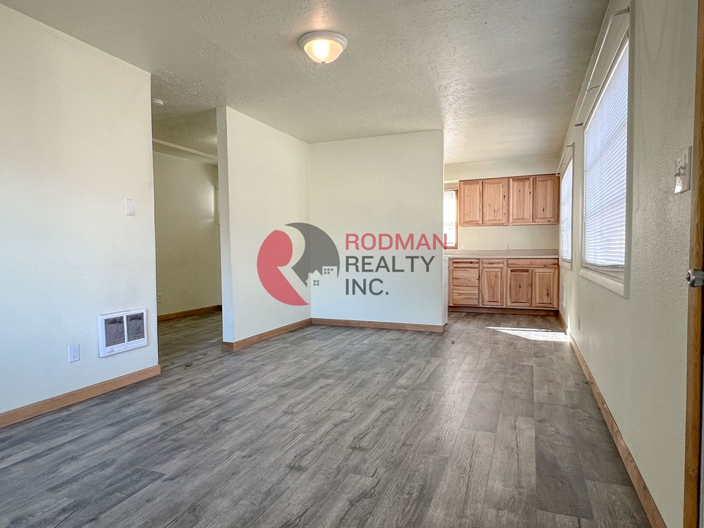 A room with Rodman Realty Inc. logo on the wall.