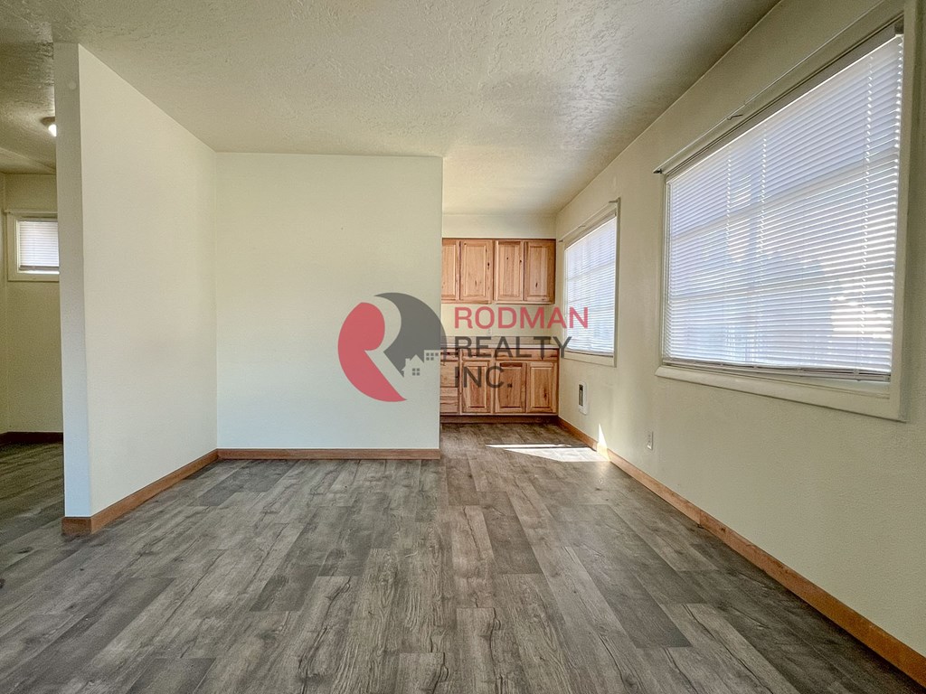 A room with a Rodman Realty logo on the wall.