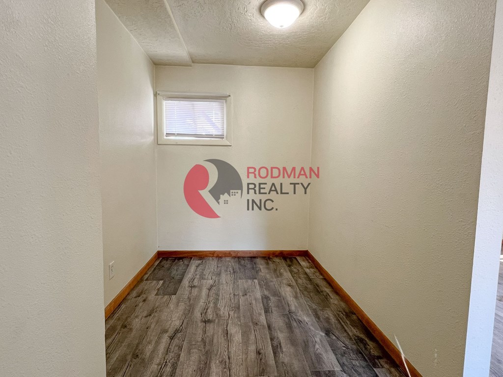 A room with Rodman Realty Inc. logo on the wall.