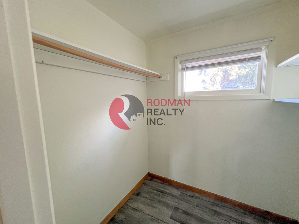 A room with Rodman Realty Inc. logo on the wall.
