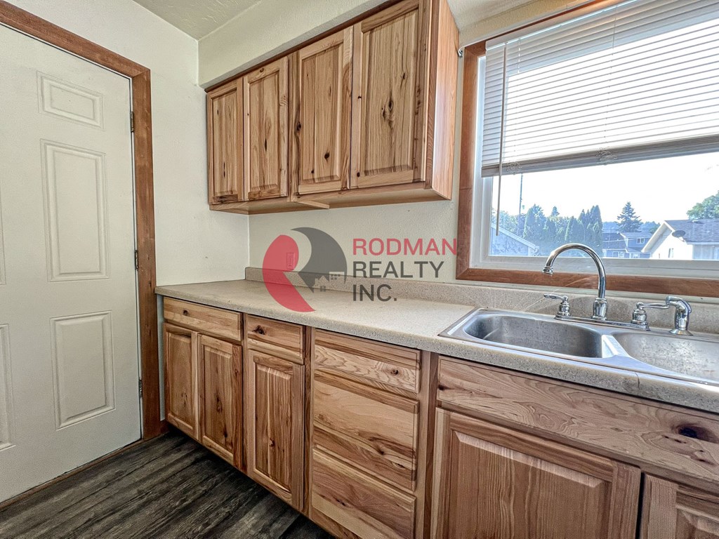 Rodman Realty Inc. logo on a kitchen counter.