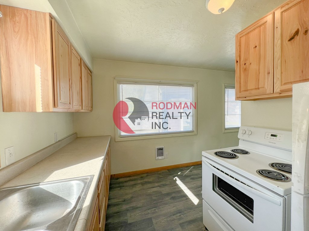 A kitchen with Rodman Realty Inc. on the wall.