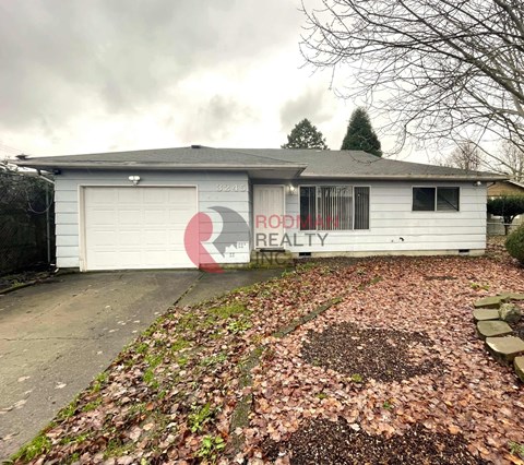 A house with a sign that says "Rod Realty" on it.