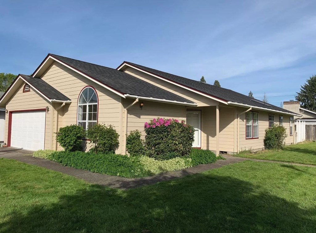 a house with a lawn and a driveway