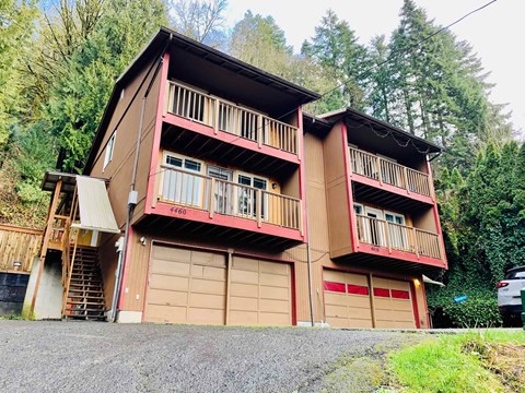 A two-story house with a balcony on the second floor.