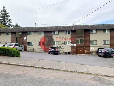 A Rodman Realty sign is painted on the side of a building.