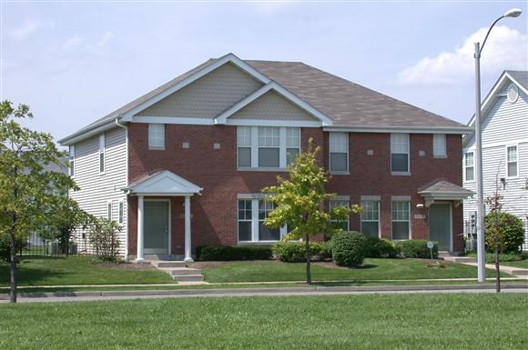 a brick house on the side of a street