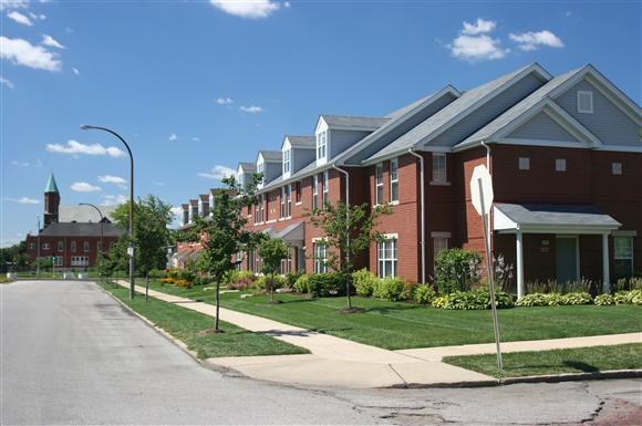 a row of houses on the side of a street