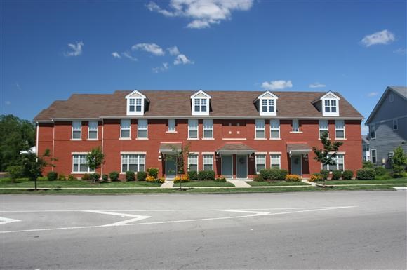 a large red brick building on the side of a street