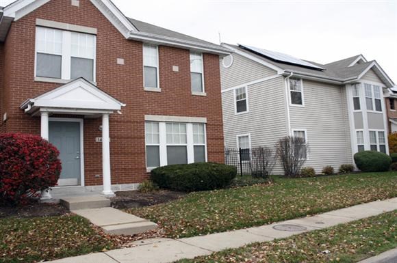 a house with a sidewalk in front of it