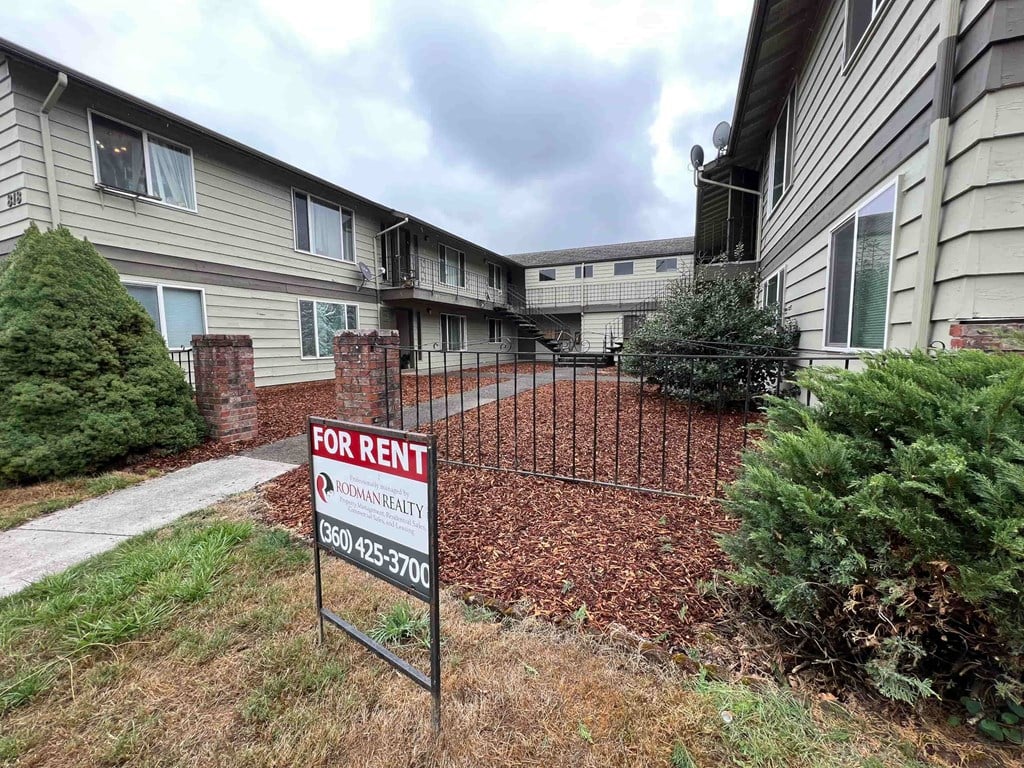 A for rent sign in front of a building.