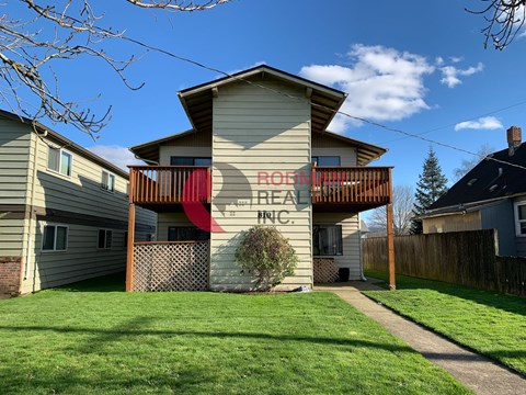 A house with a red sign that says "BROOKS PLAZA" on it.