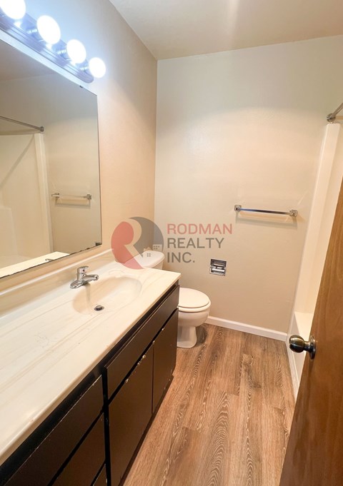 A bathroom with a white sink and a toilet.