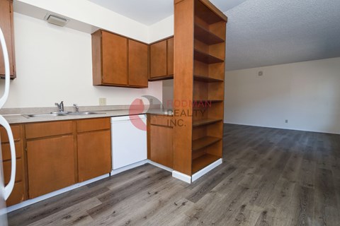 A kitchen with wooden cabinets and a white countertop.