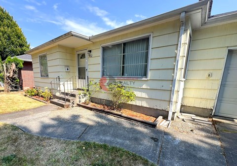 A house with a sign that says "REALTY" on the front window.