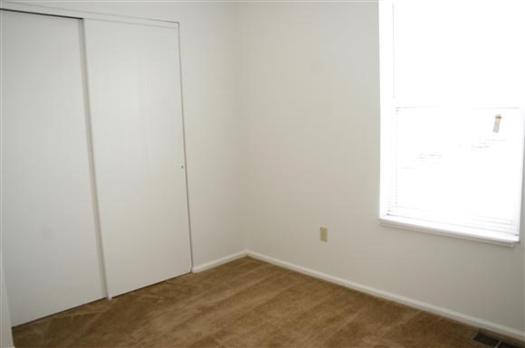 a white room with a window and a door