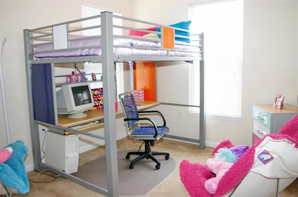a bedroom with a bunk bed and a desk
