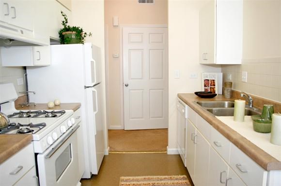 a kitchen with a stove refrigerator and a sink