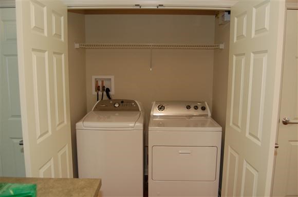 a small closet with two washing machines in it