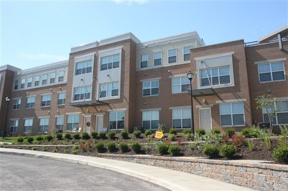 a large brick building with a sidewalk in front of it