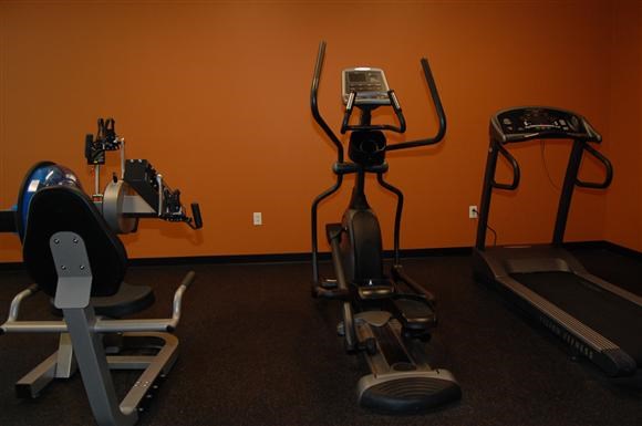a group of exercise equipment in a gym