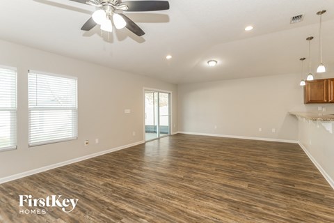 a living room with a wood floor and a ceiling fan