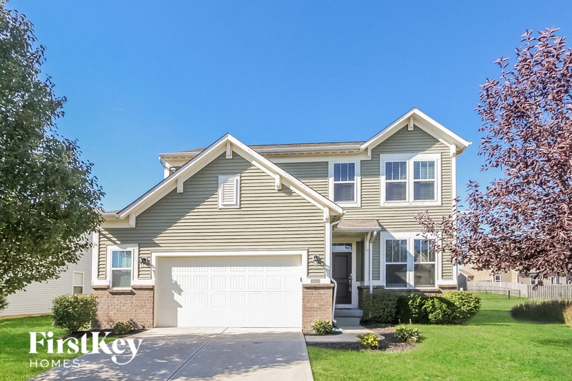 a home with a white garage door in front of it
